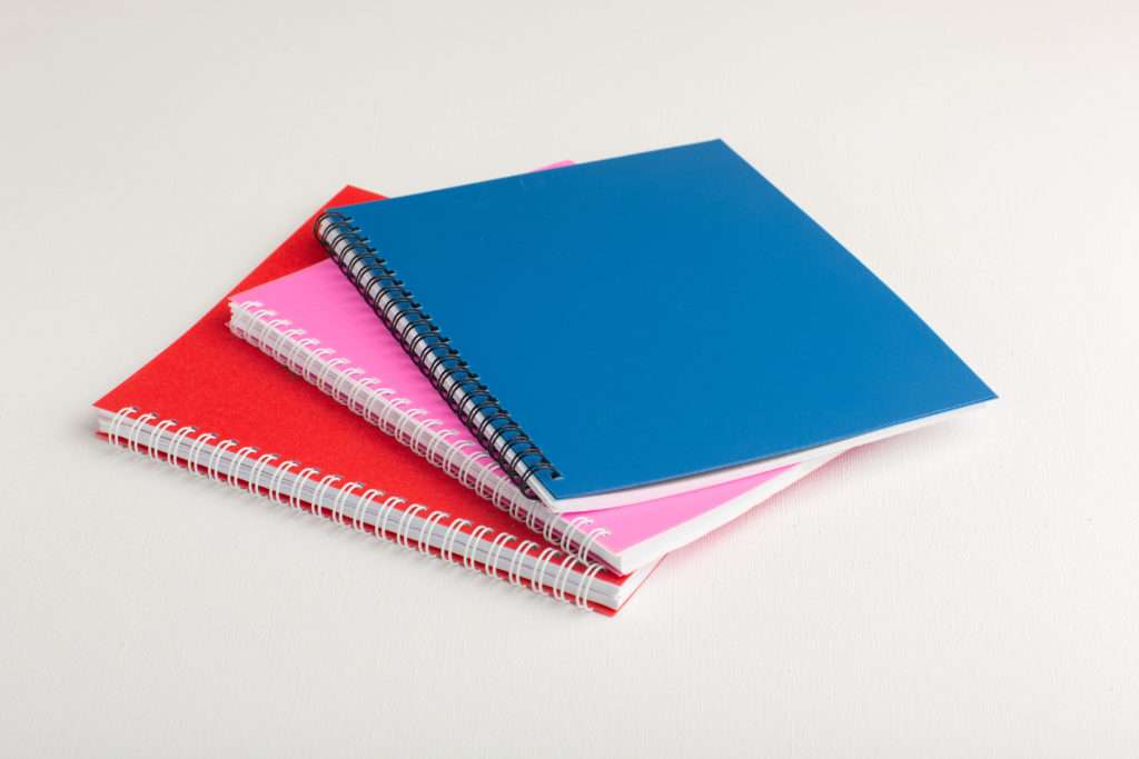 front-view-colorful-copybooks-white-surface